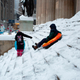 People playing as snow falls in Wall Street during a winter storm on February 1, 2021 in New York City.